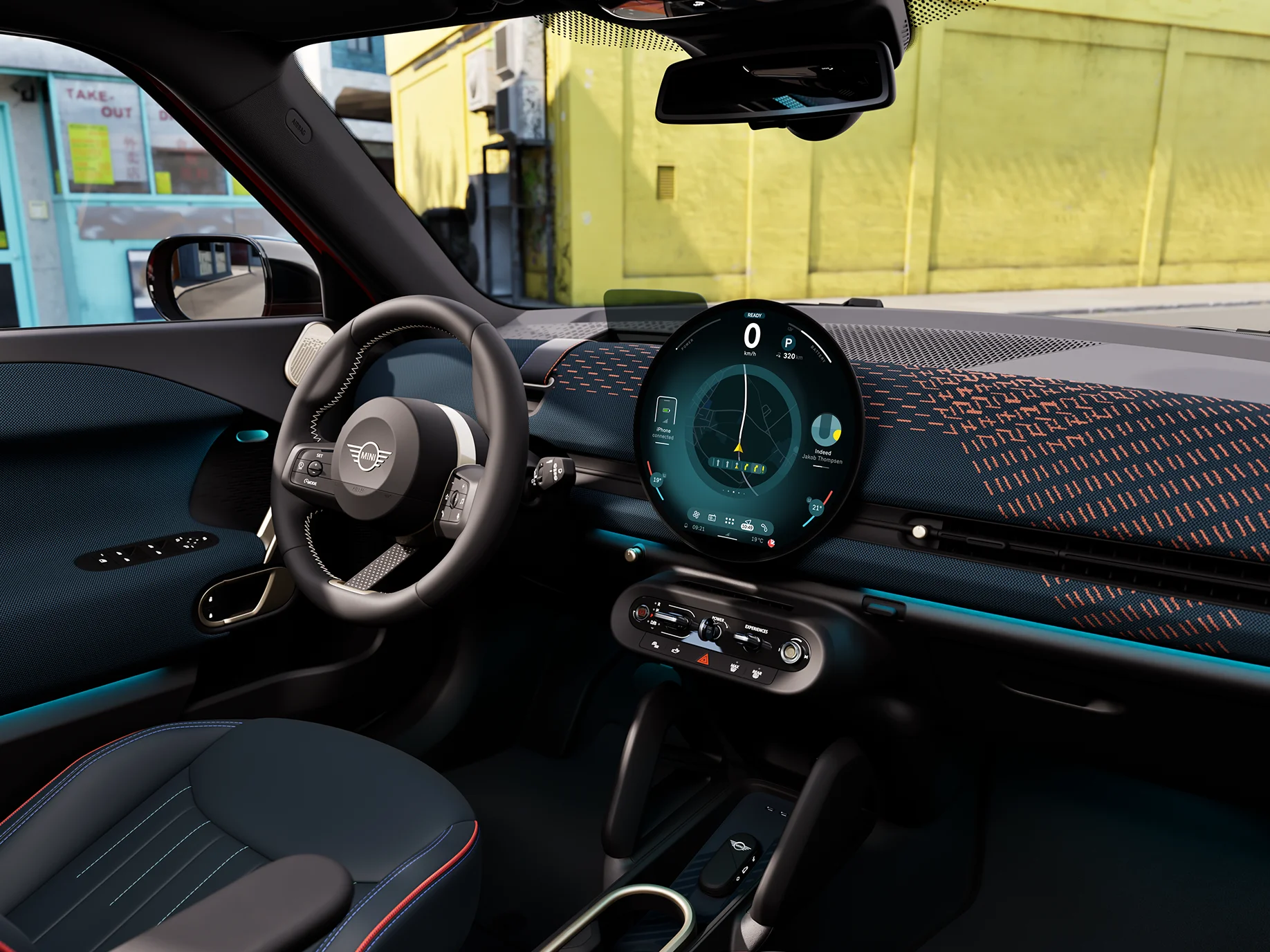 Interior view of the all-electric MINI Aceman focusing on the dashboard, the interaction unit and the steering wheel.