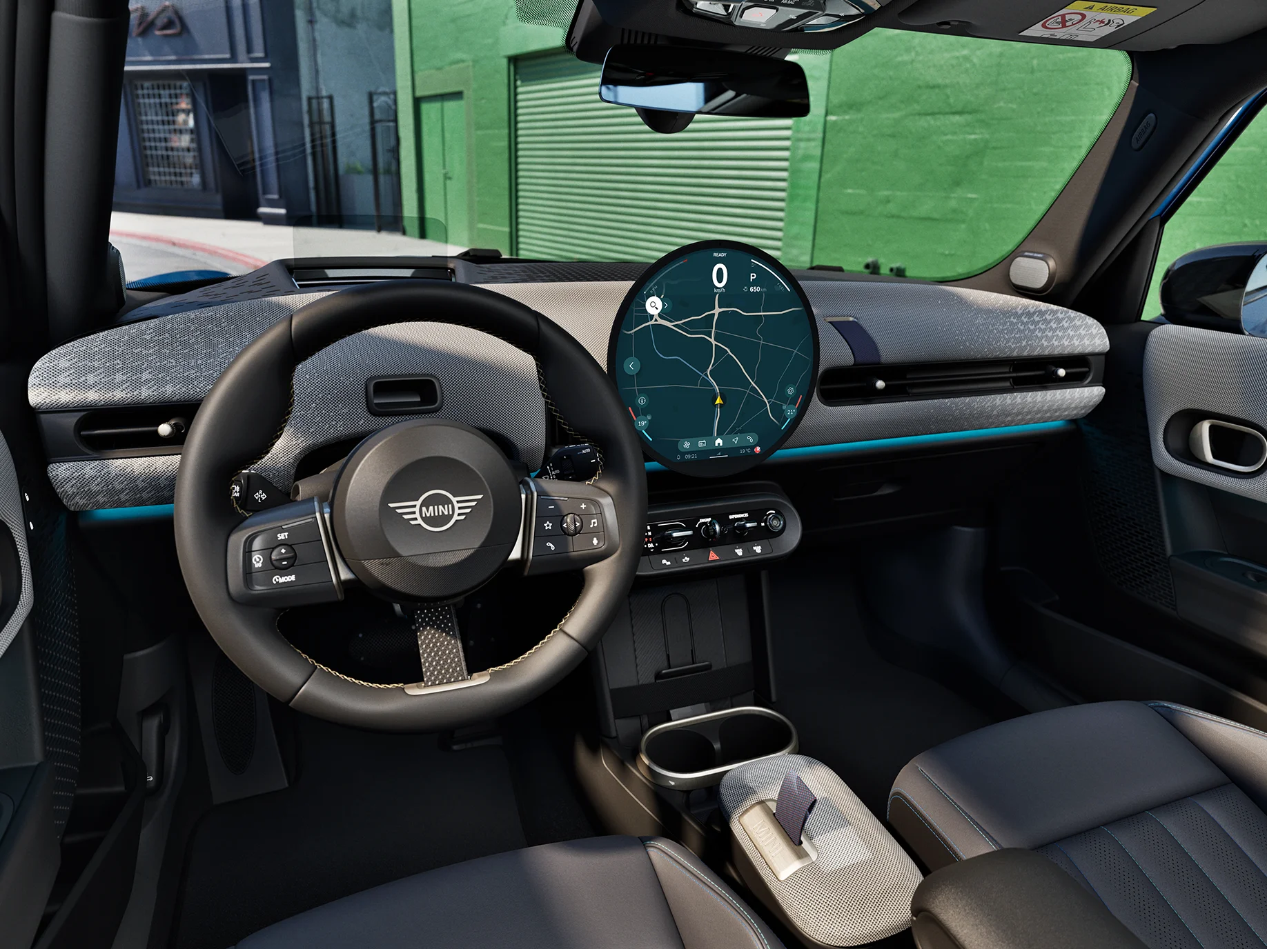 Interior view of the MINI Cooper 5-Door focusing on the steering wheel, the dashboard and the interaction unit.