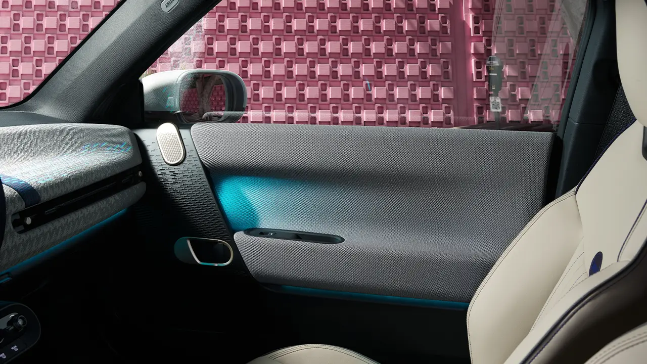 Interior view of all-electric MINI Cooper door with ambient lighting