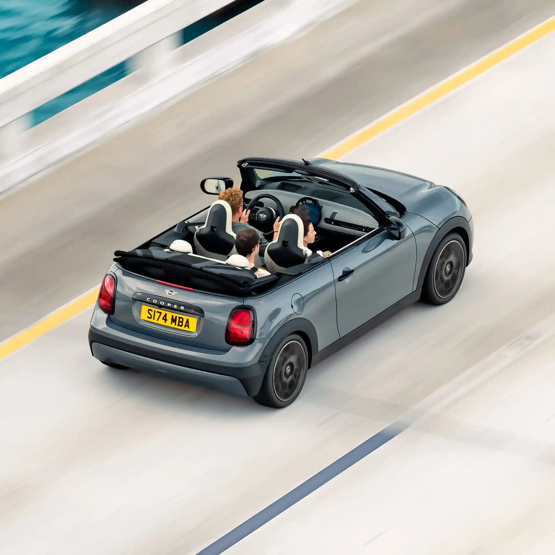 Top rear view of a driving MINI Cooper Convertible on a street