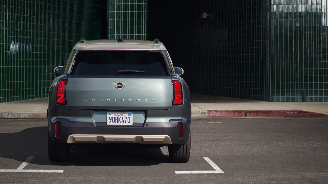 Rear view of a parking MINI Countryman in Smokey Green with Vibrant Silver Roof