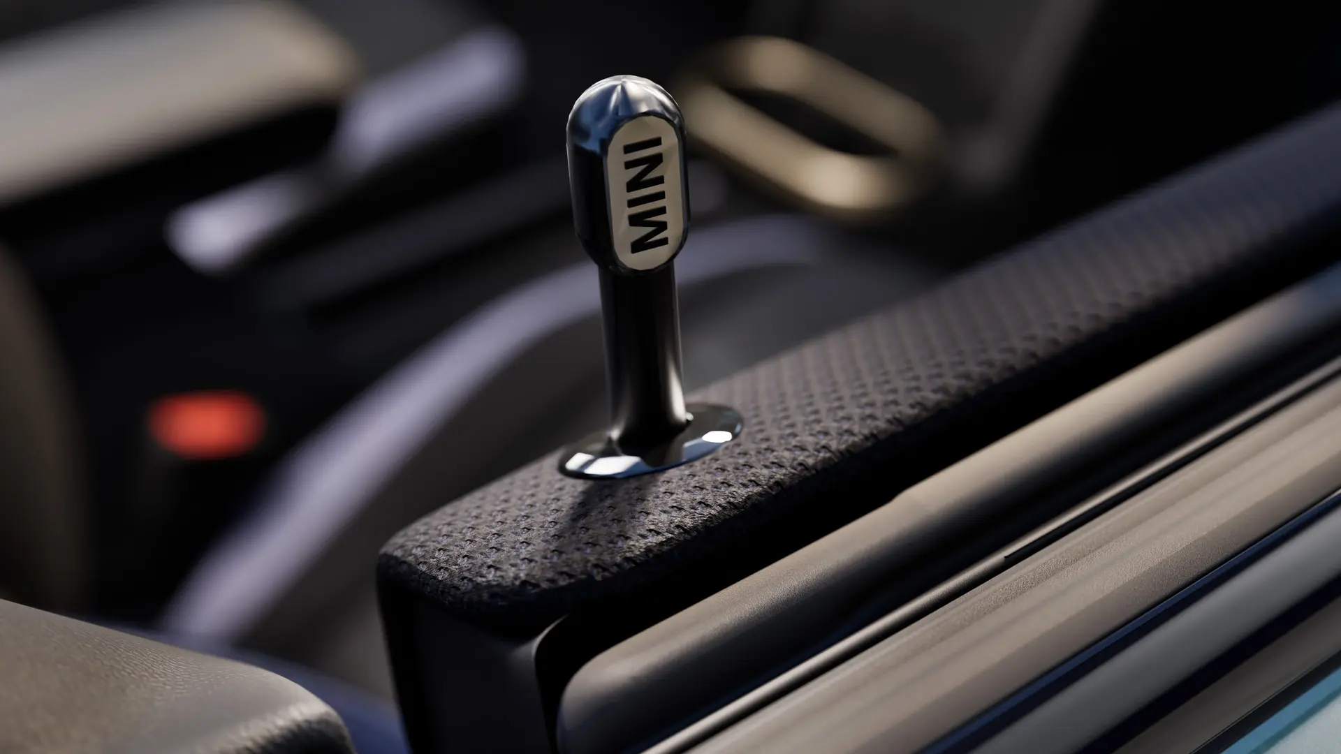 Close up of Genuine MINI interior door locking pin in black anodised aluminium.