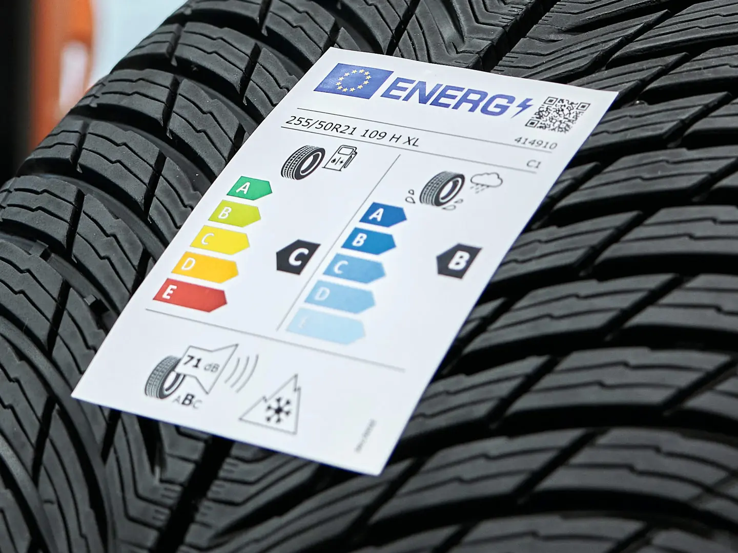 An EU tyre label sticker attached to the tread of a new tyre.