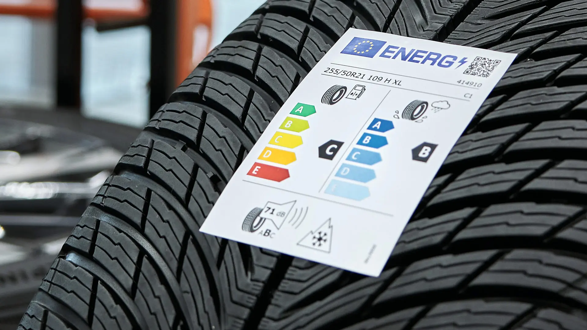 An EU tyre label sticker attached to the tread of a new tyre.
