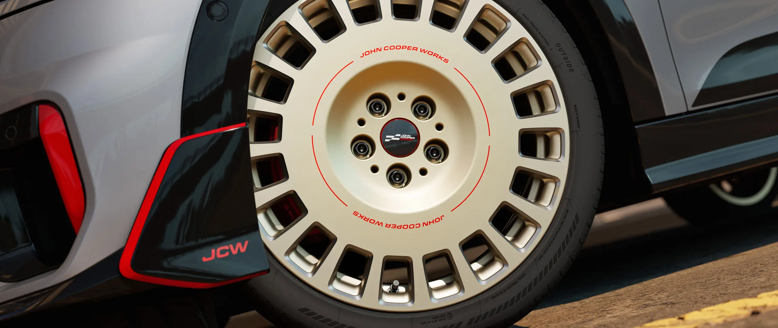 Close-up of the details on an 18" JCW Rallye Spoke 964 wheel in Bicolour Vibrant Silver, diamond-milled and front winglet.