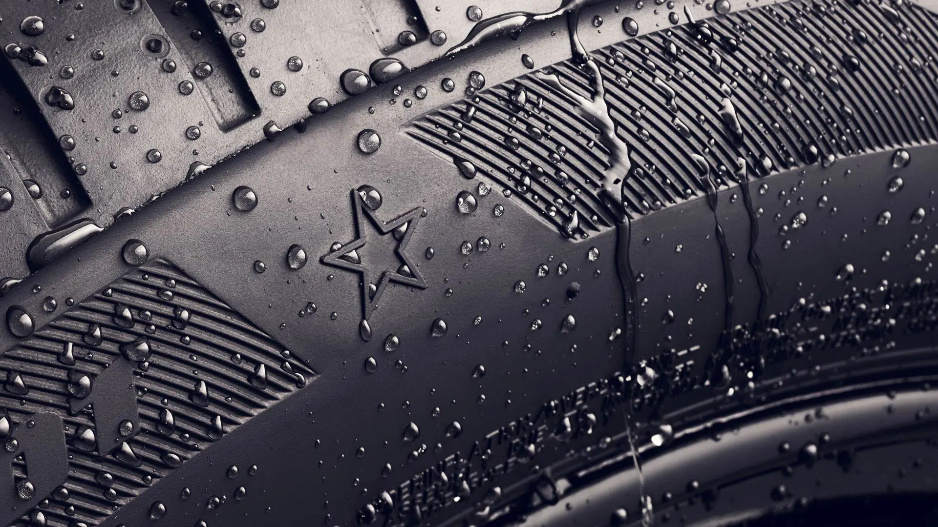 Close-up of a tyre sidewall showing the star symbol, which indicates it is approved for optimal performance on MINI vehicles. 