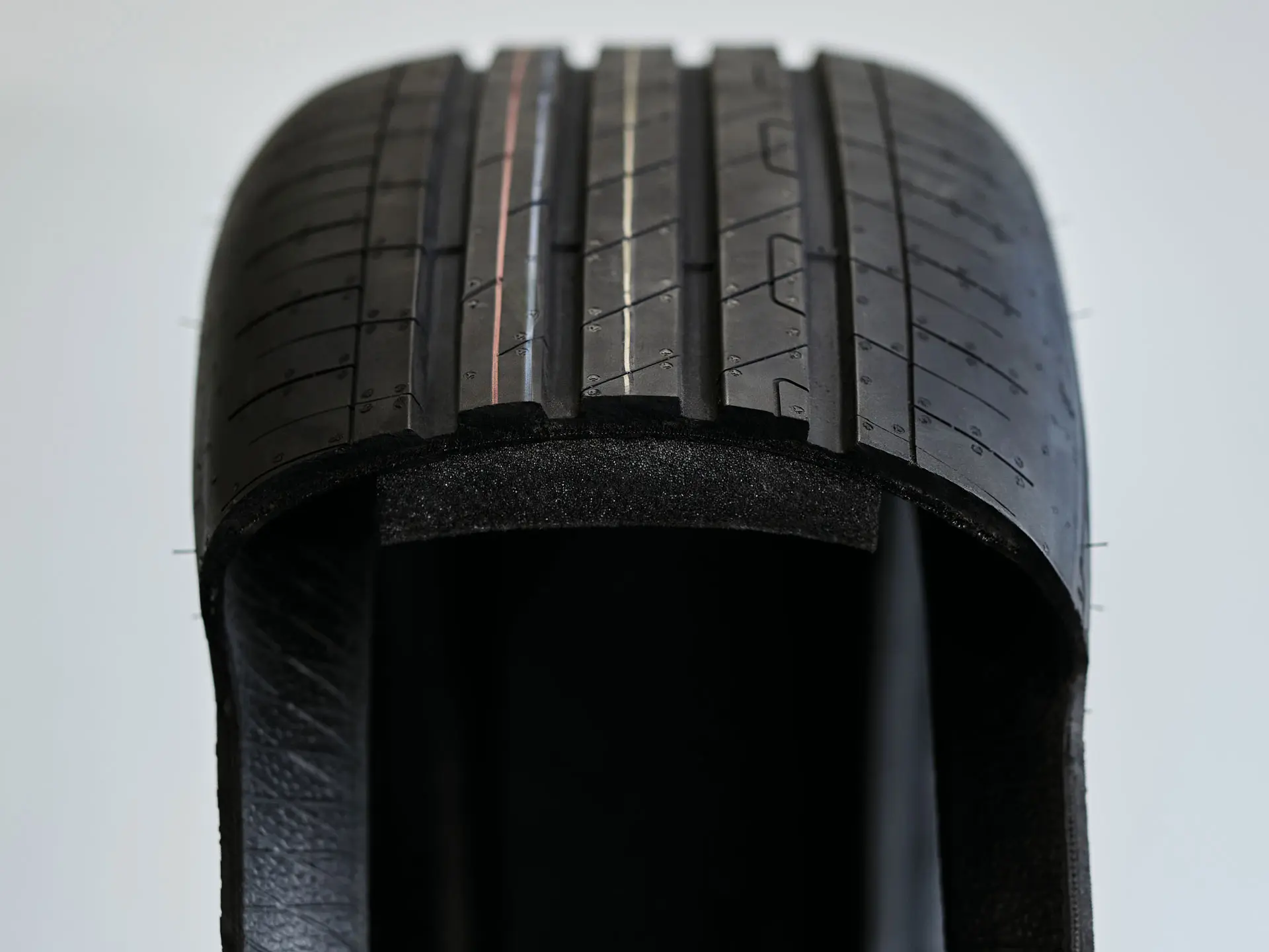 Cutaway view of a run-flat tyre showing the thickened, sturdy sidewall that supports the weight of the vehicle after a puncture.