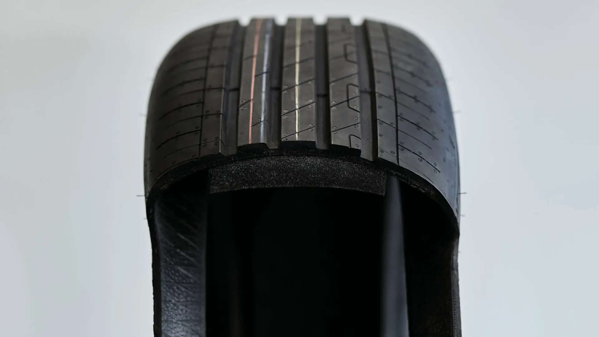 Cutaway view of a run-flat tyre showing the thickened, sturdy sidewall that supports the weight of the vehicle after a puncture.