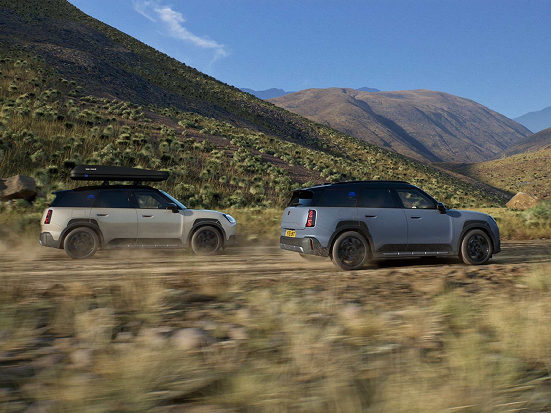 Image of two MINI Countryman Untamed Edition vehicles driving, from the back.