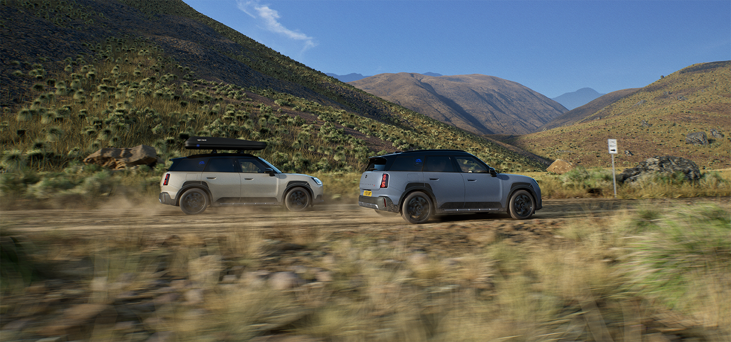Image of two MINI Countryman Untamed Edition vehicles driving, from the back.