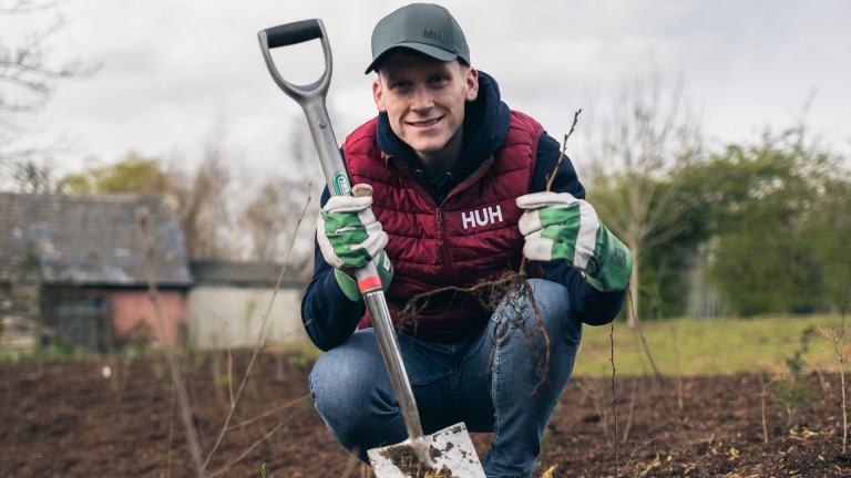 Mark Donnelly holding a sprout and shovel