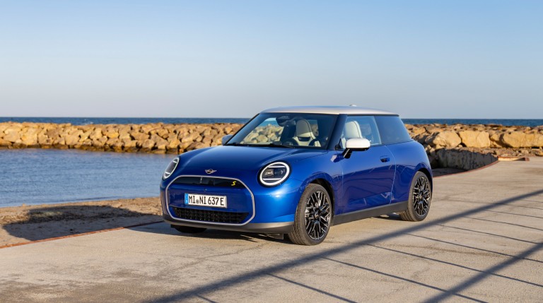 all-electric MINI Cooper parked by the sea