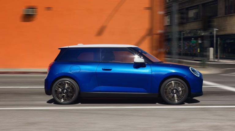 all-electric MINI Cooper side driving down road
