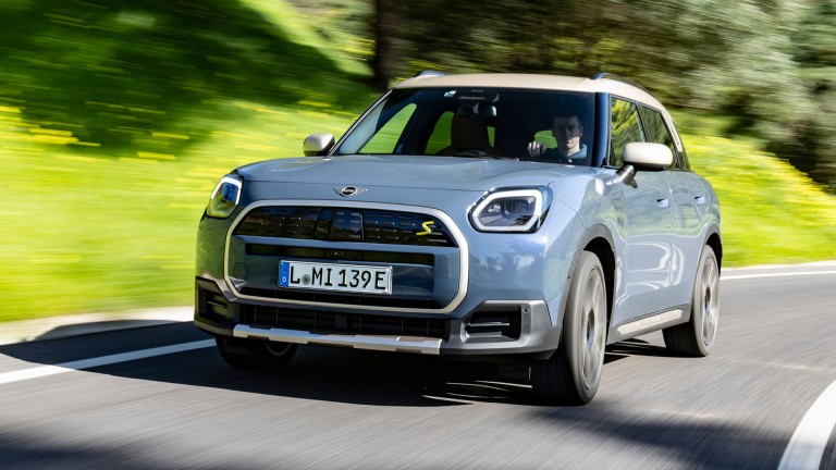 all-electric MINI Countryman driving up road slightly turning corner