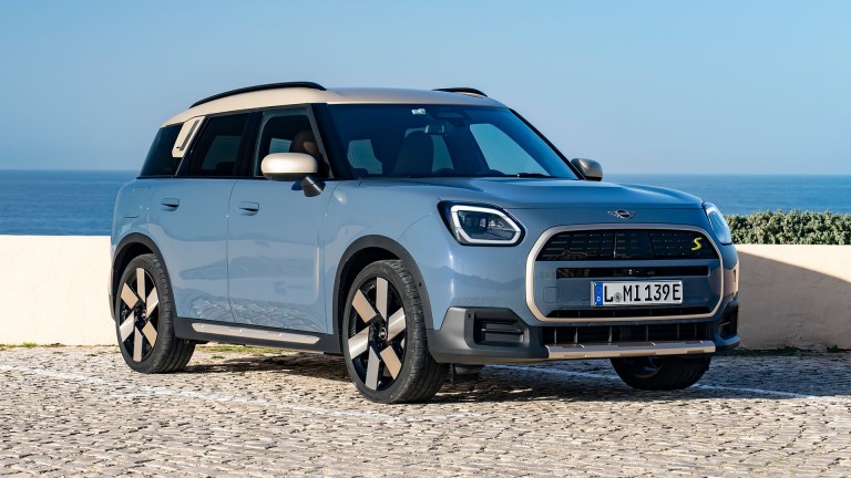all-electric MINI Countryman side view with sea in background