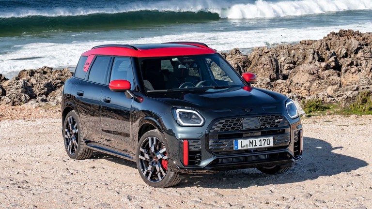 MINI Countryman John Cooper Works parked on a beach, wave in background