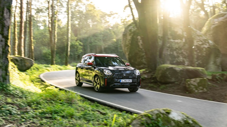 MINI Countryman John Cooper Works side and front driving through forest