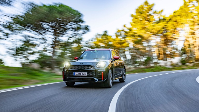 MINI Countryman John Cooper Works driving down a slight cornered hill